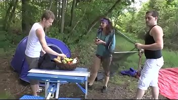 A girl fucked hard by two guys in a camping