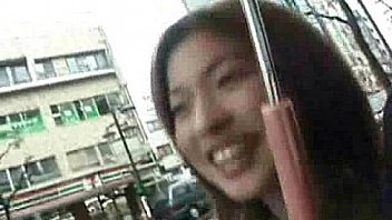 An Asian girl is walking down the street, being ques from http://alljapanese.net