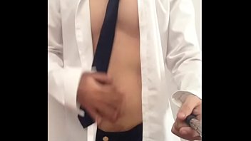 Sexy slim Asian jerking off in work clothes